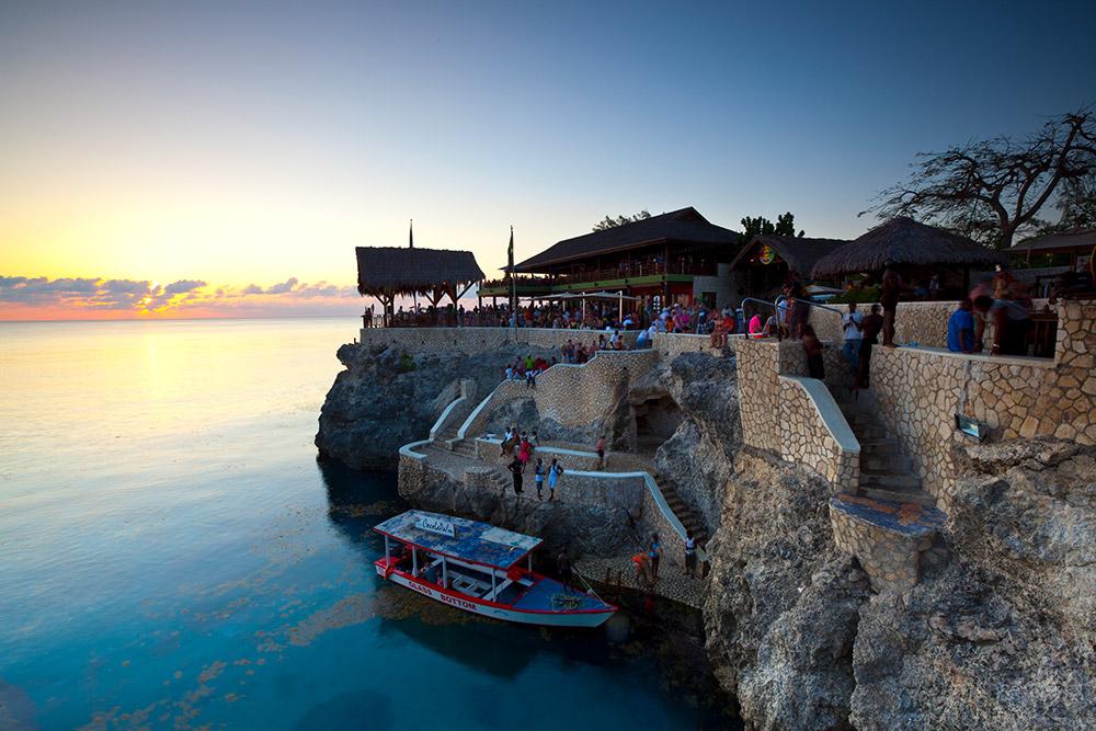 People hanging out at Rick's Cafe at sunset