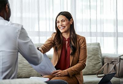 A woman shakes coworker's hand
